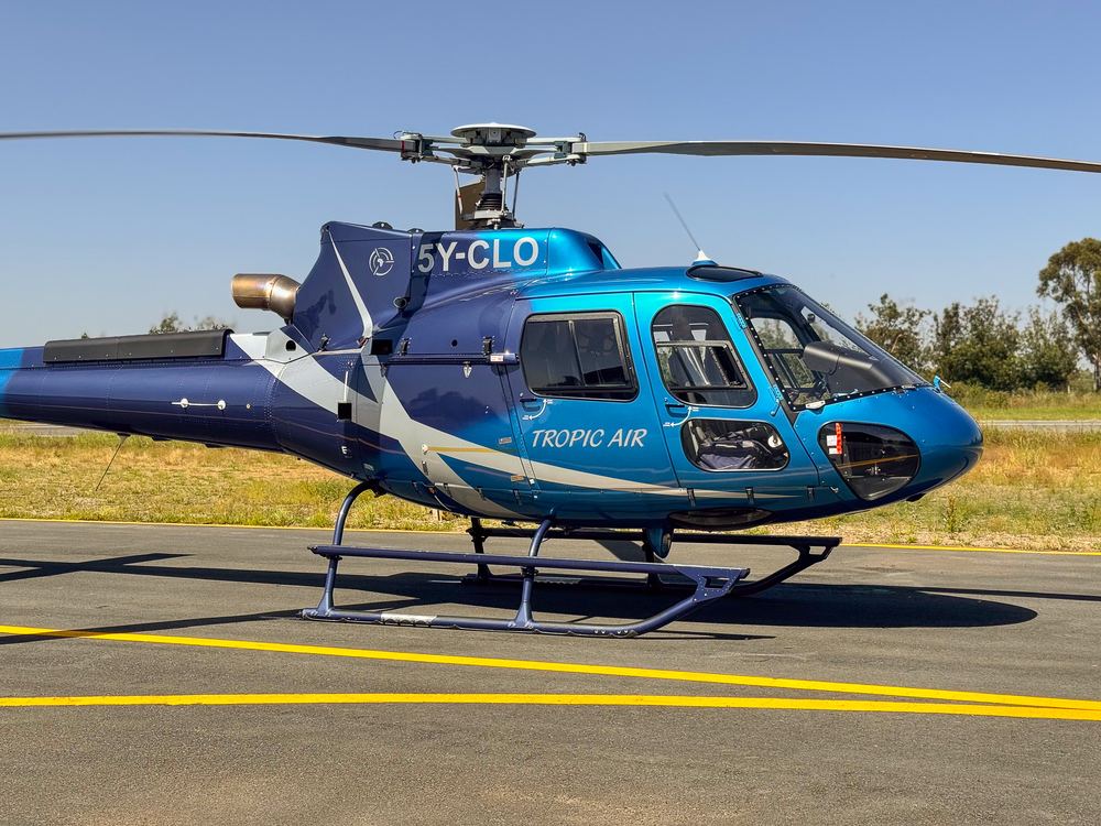 Tropic Air helicopter parked on the tarmac, ready for a VIP or corporate transfer